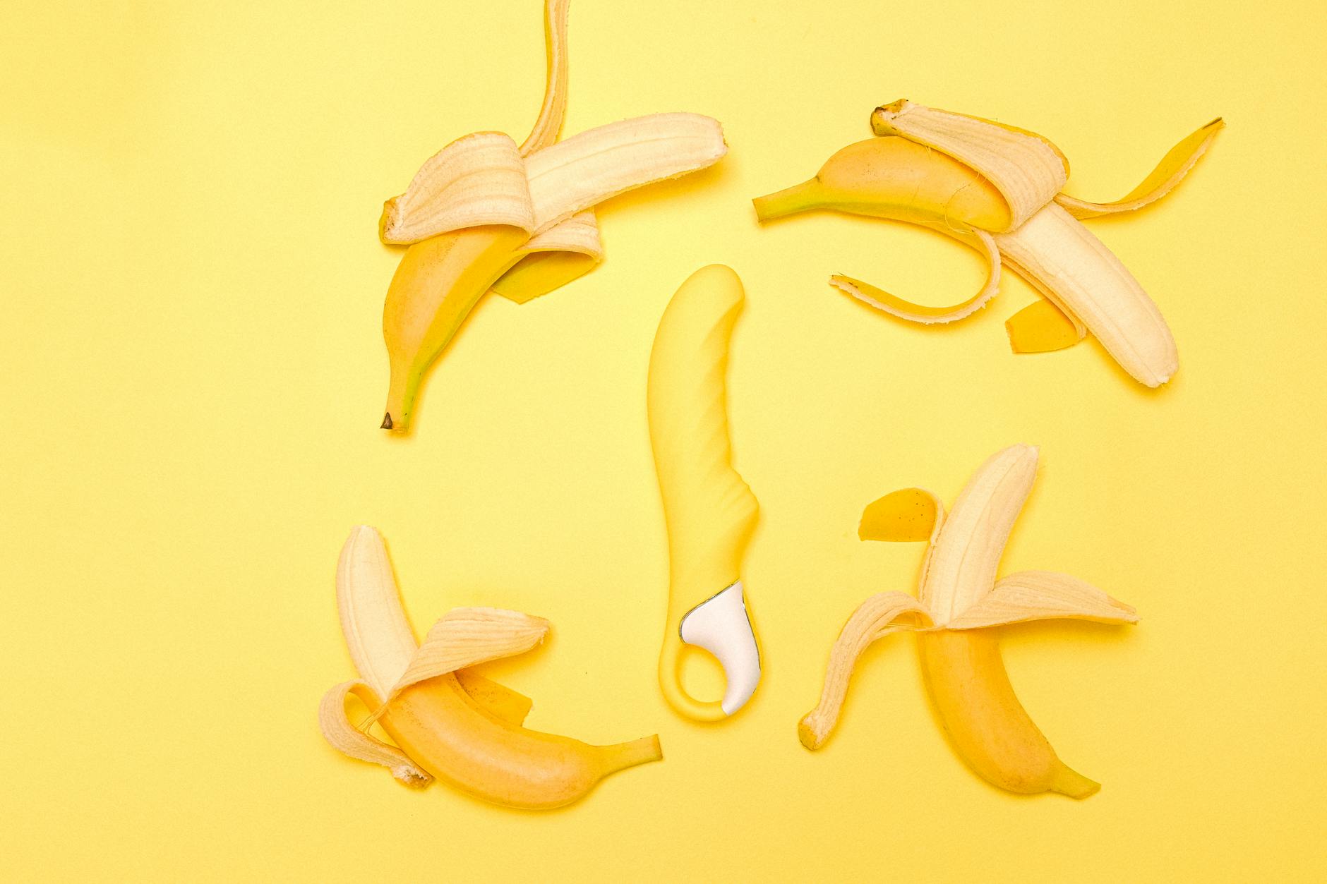 A vibrant yellow lemon vibrator displayed on a minimalist background